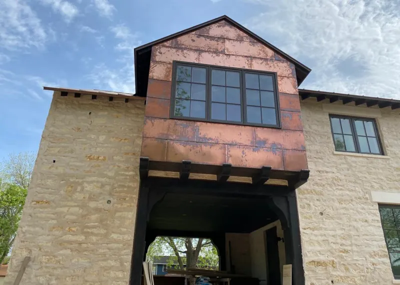 Copper metal panel facade on a stone building for Metal Roof Coating in Orange Cove