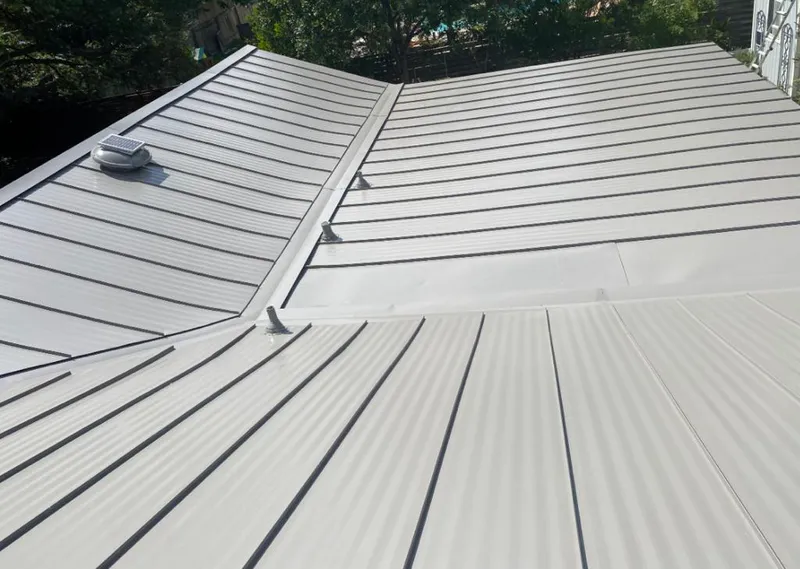 Solar attic fan installed on a metal roof for Roof Ventilation in Orange Cove